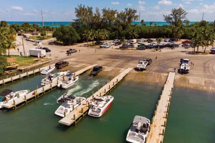 Boats launching at a busy multi-lane public boat ramp